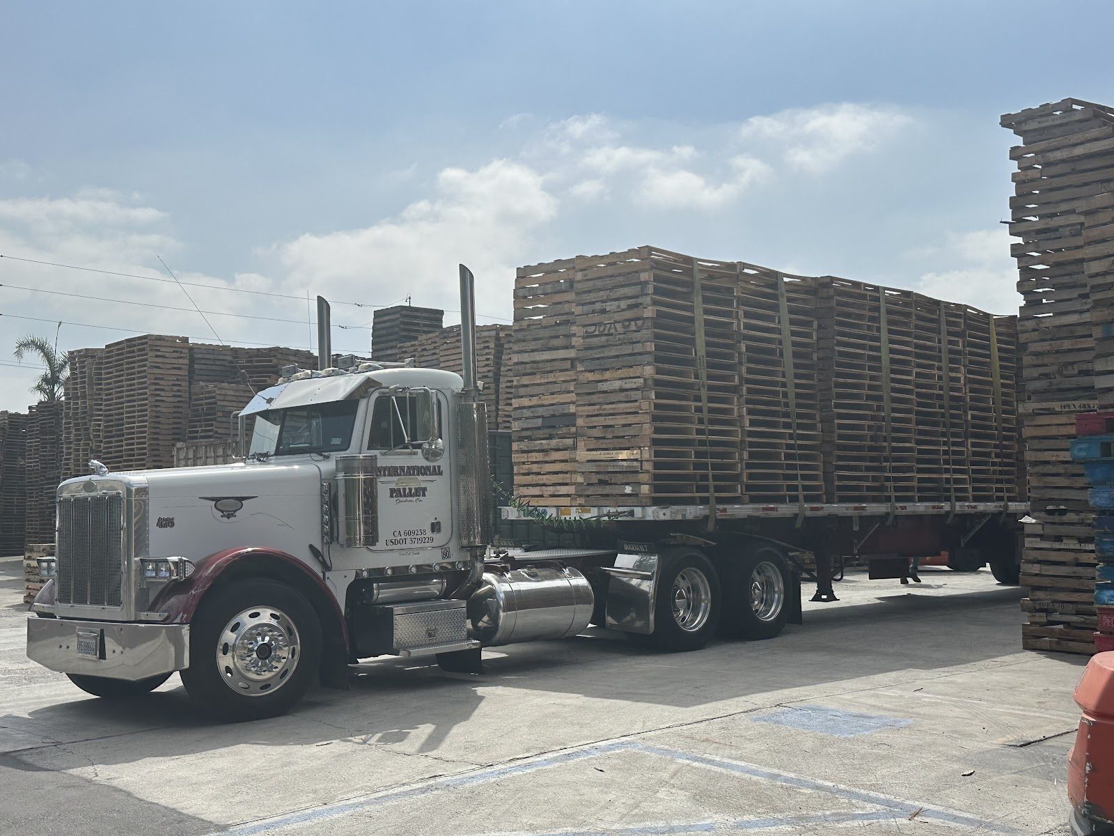 An International Pallet flatbed truck fully loaded with wood pallets at the Gardena, CA yard